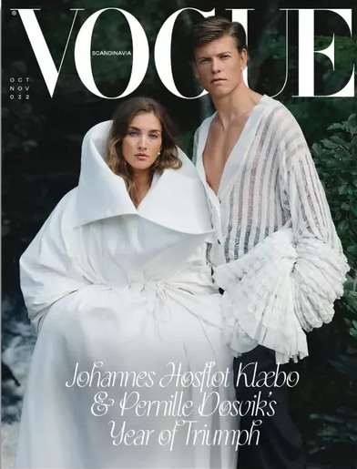 Forsiden af Vogue Scandinavia nr. 32 med Johannes Høsflot Klæbo og Pernille Døsvik i hvide outfits ved et vandfald i en skov uden for Trondheim.